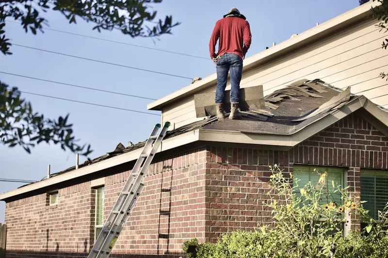 Professional roofer working on a residential roof in Tower Oaks Meadows